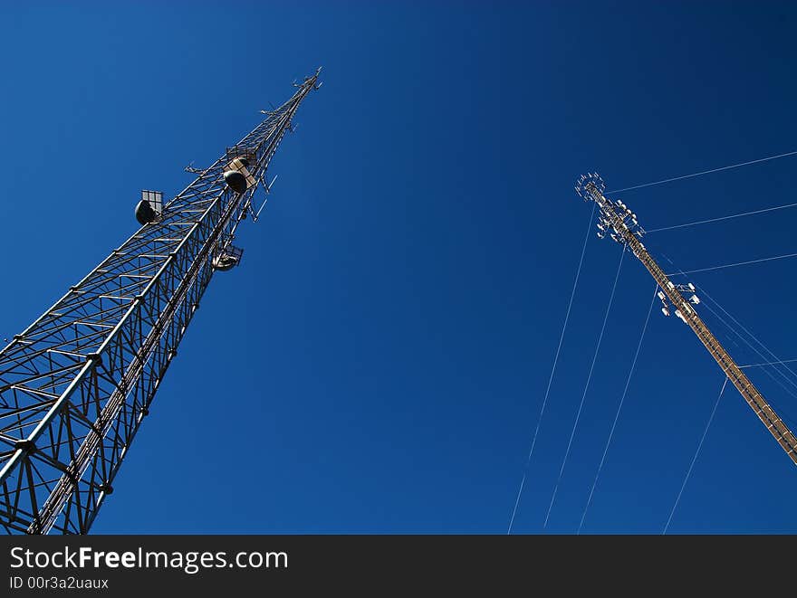 Cell towers with a deep blue sky behind them. Cell towers with a deep blue sky behind them.