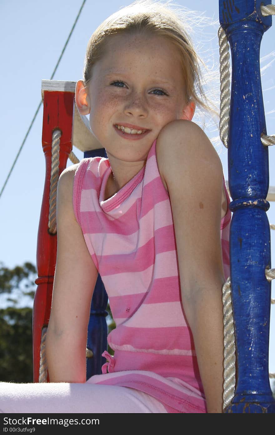 White caucasian girl sitting on a play boat with no worries. White caucasian girl sitting on a play boat with no worries