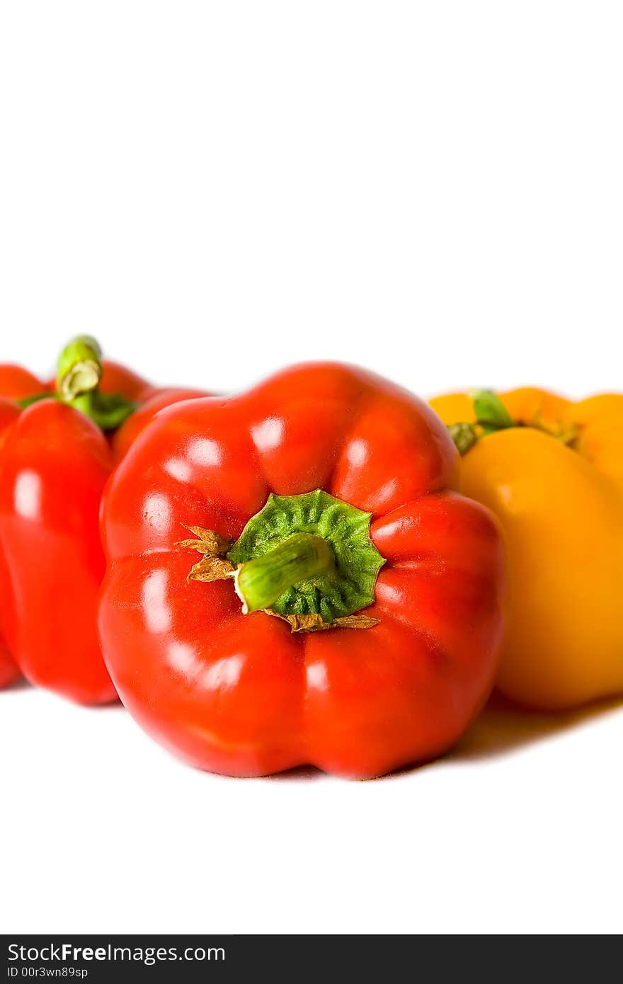 Fresh Red and Yellow Bell Peppers isolated on a white background. Fresh Red and Yellow Bell Peppers isolated on a white background.