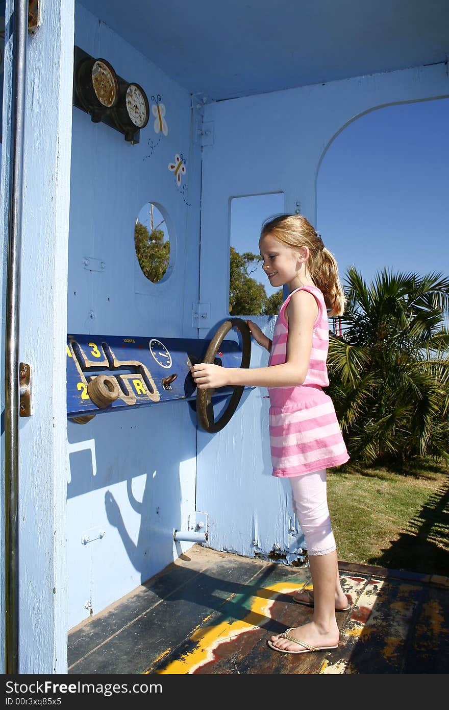 White caucasian child playing on a play play train at a kiddies garden. White caucasian child playing on a play play train at a kiddies garden