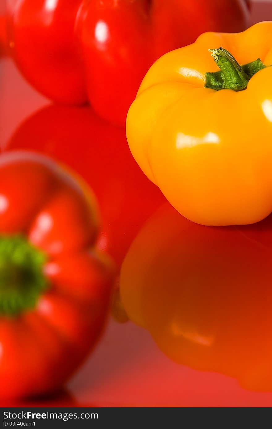 Red and yellow bellpepper macro on a red serving dish. Red and yellow bellpepper macro on a red serving dish.