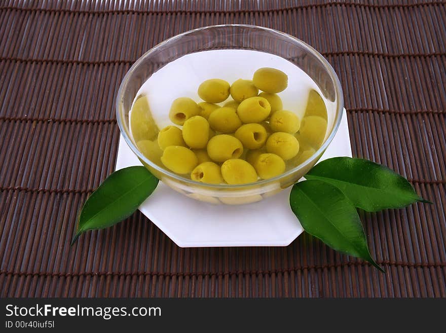 A small bowl of olives on a table