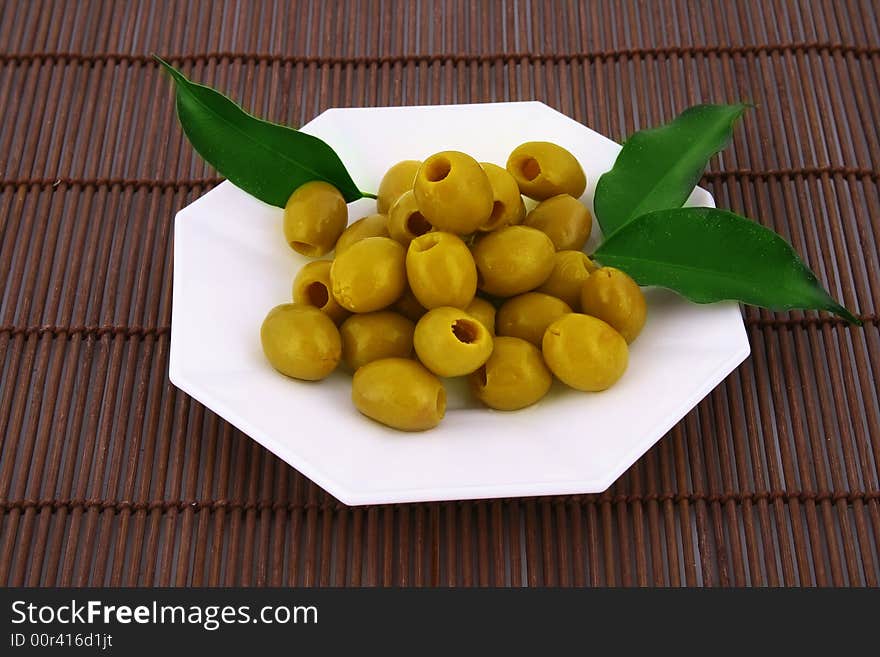 A small bowl of olives on a table