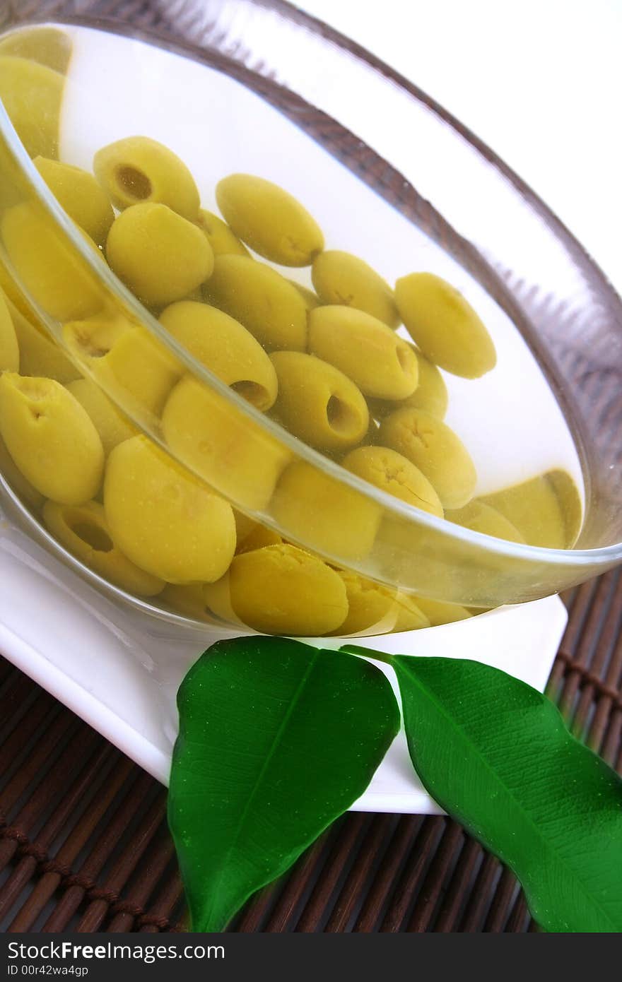 A small bowl of olives on a table