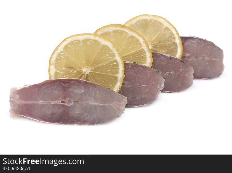 Slices of fish and lemon isolated on white background