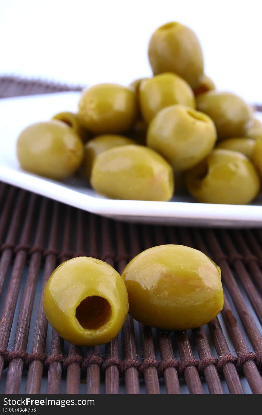 A small bowl of olives on a table