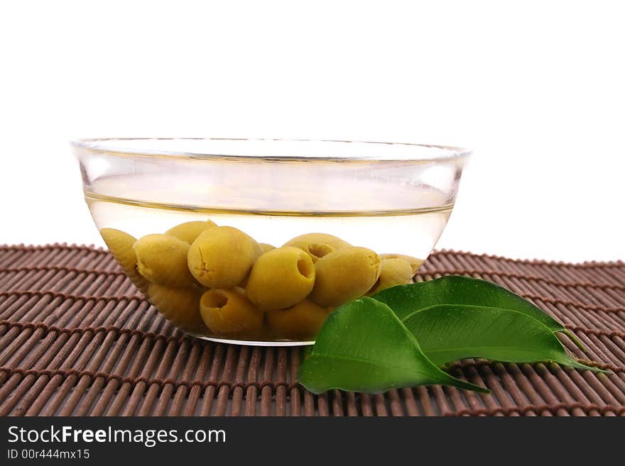 A small bowl of olives on a table