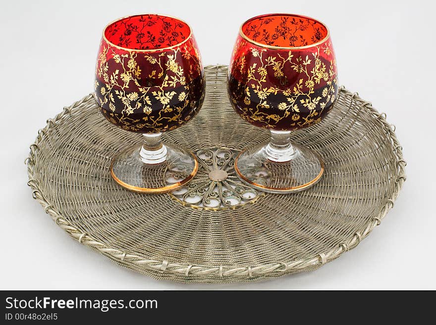 Two glasses with wine on a wattled metal tray