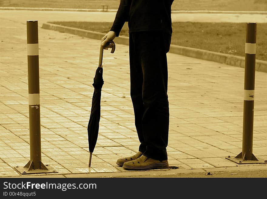 Abstract picture of a waiting person with umbrella