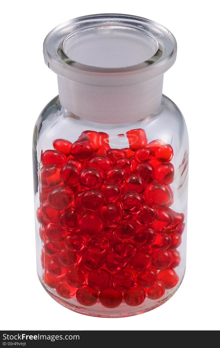 Red pills in a vial, isolated on white.