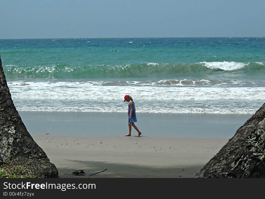 Girl strolling along an empty beach