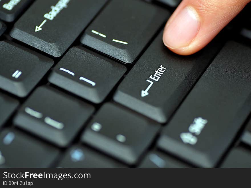 Close up of a male finger pressing enter on a keyboard. Close up of a male finger pressing enter on a keyboard