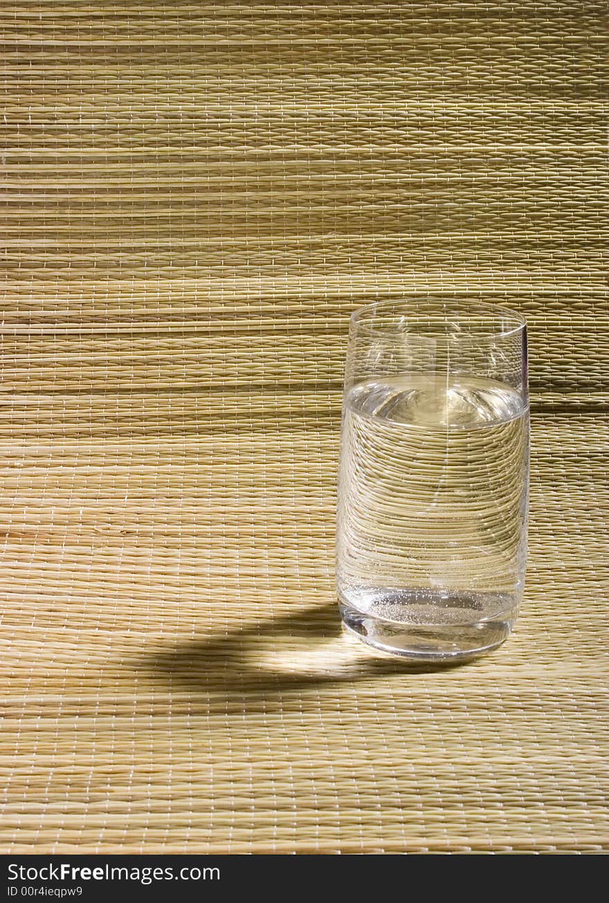 Glass Of Water On Wicker Background