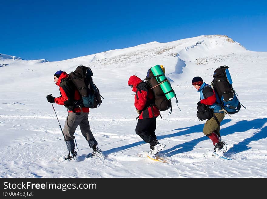 Tourists are in winter in mountains