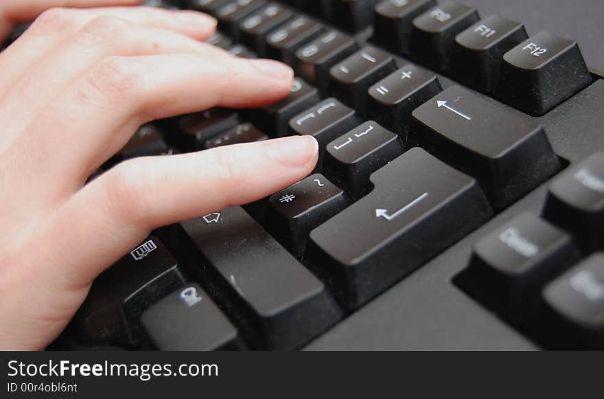 Hands typing on a black keyboard. Hands typing on a black keyboard