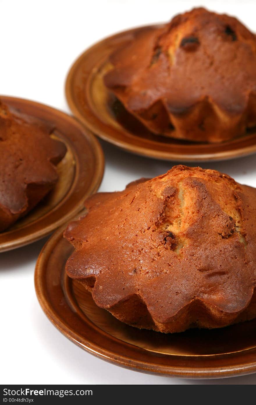 Appetizing fruitcakes with raisin on ceramic plate