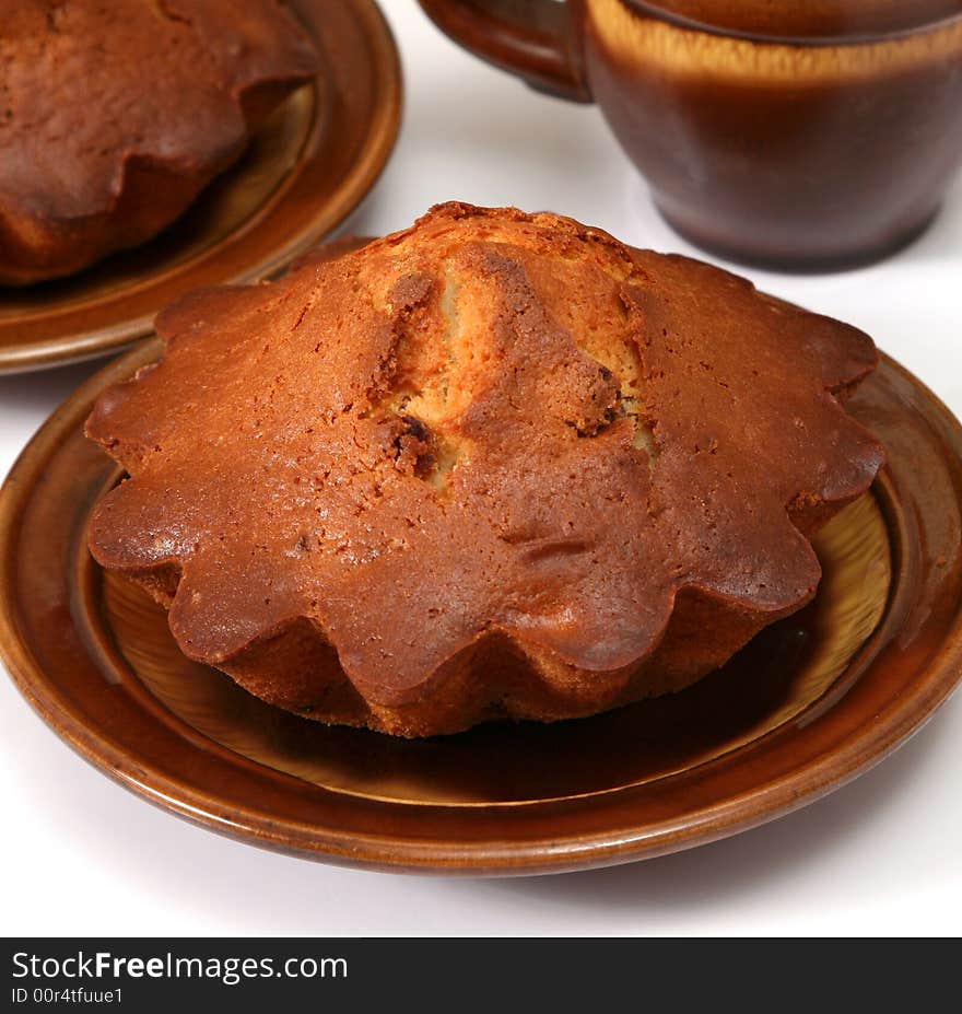 Appetizing fruitcakes with raisin on ceramic plate