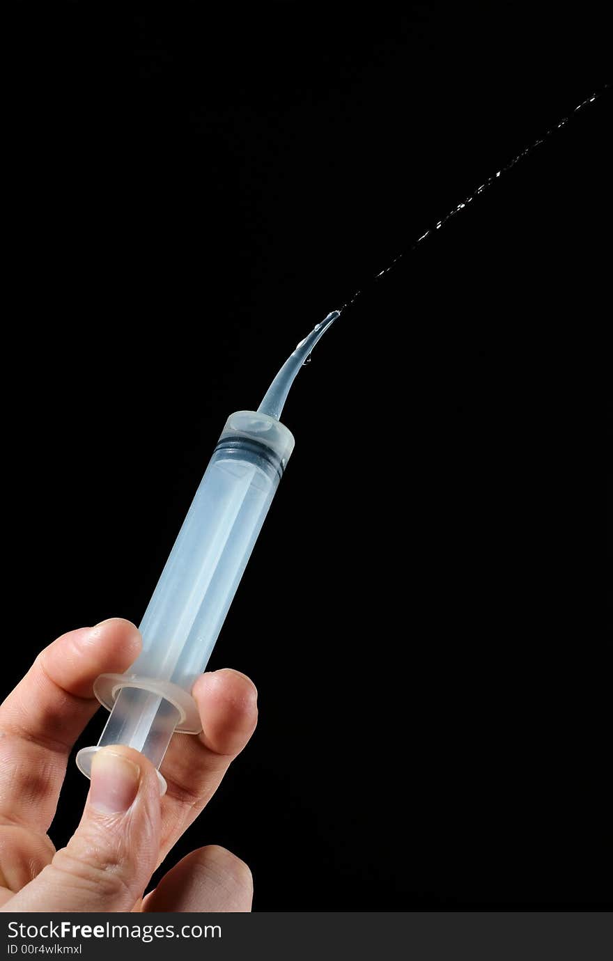 A plastic syringe used at the dentist office. A plastic syringe used at the dentist office.