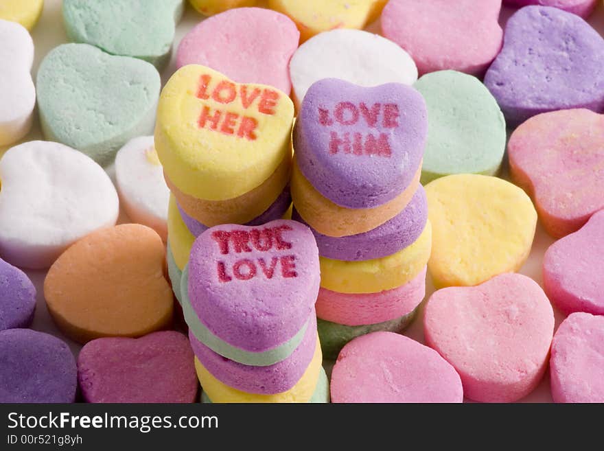 Closeup of colorful Valentine hearts in a stack with romantic words. Closeup of colorful Valentine hearts in a stack with romantic words.