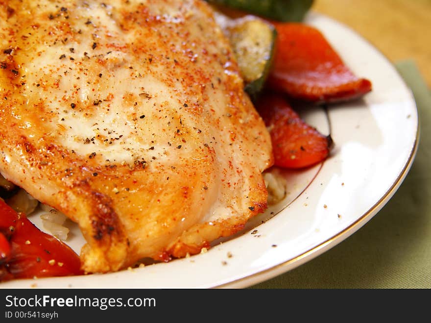 Broiled chicken breast with cayenne and cracked black pepper, served with zucchini, red bell peppers, and wild brown rice. Broiled chicken breast with cayenne and cracked black pepper, served with zucchini, red bell peppers, and wild brown rice.