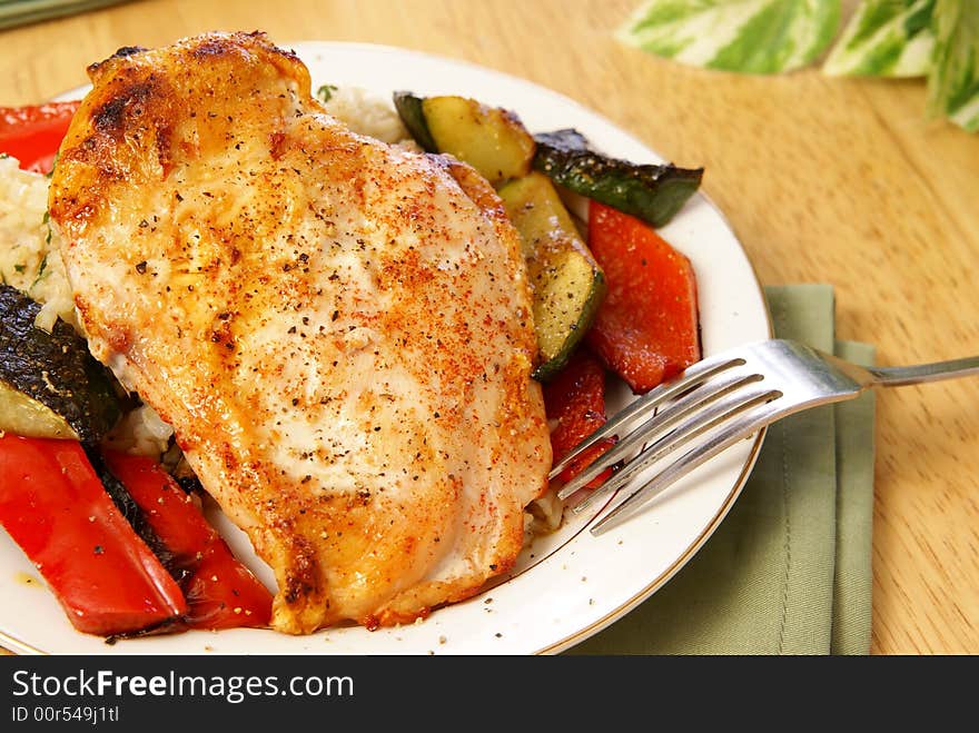 Broiled chicken breast with cayenne and cracked black pepper, served with zucchini, red bell peppers, and wild brown rice. Broiled chicken breast with cayenne and cracked black pepper, served with zucchini, red bell peppers, and wild brown rice.