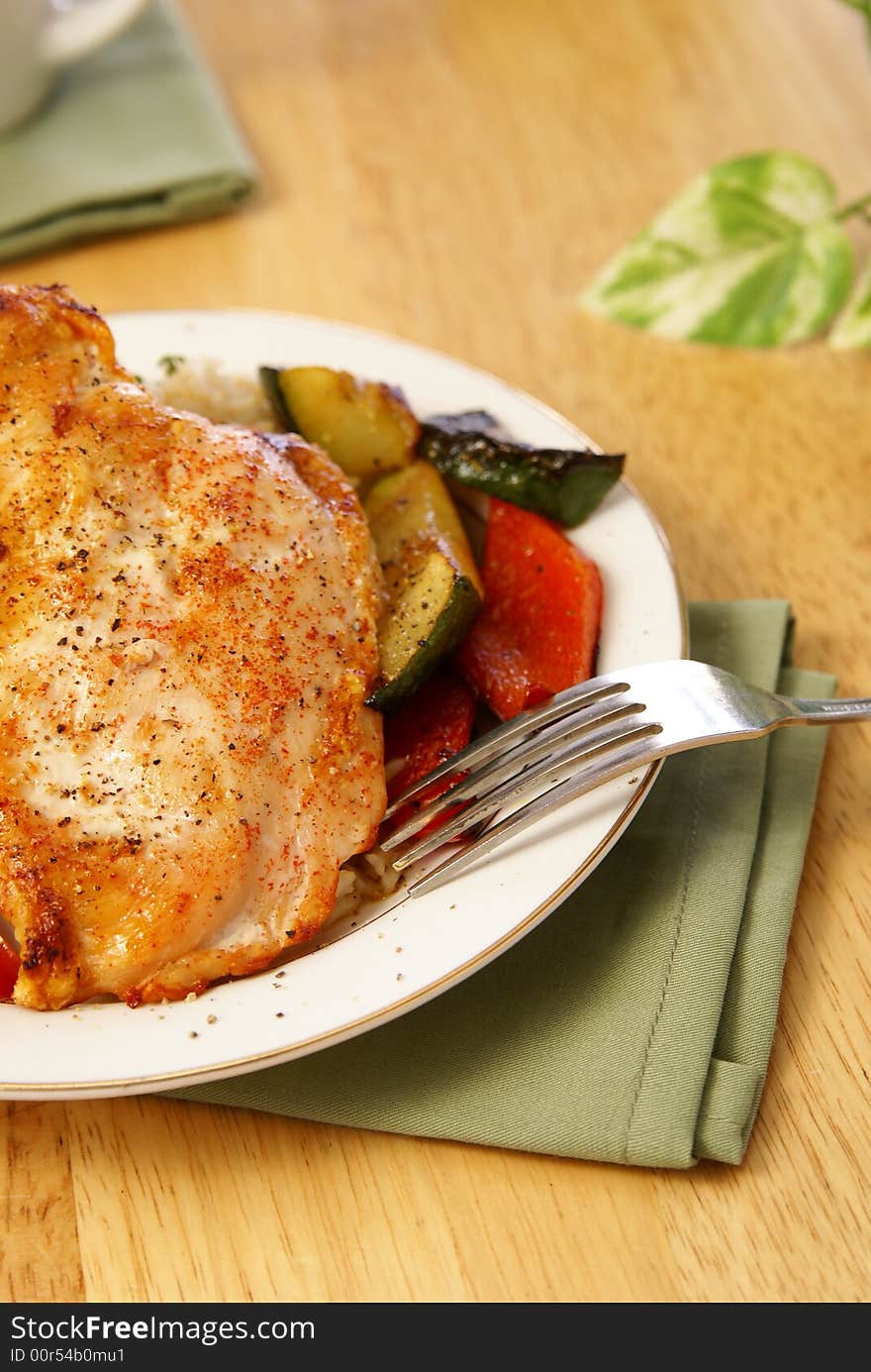 Broiled chicken breast with cayenne and cracked black pepper, served with zucchini, red bell peppers, and wild brown rice. Broiled chicken breast with cayenne and cracked black pepper, served with zucchini, red bell peppers, and wild brown rice.