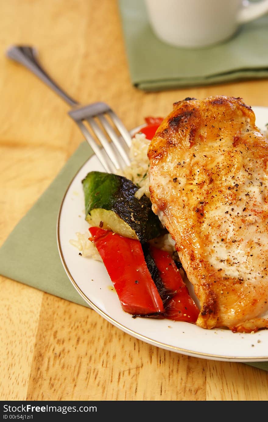 Broiled chicken breast with cayenne and cracked black pepper, served with zucchini, red bell peppers, and wild brown rice. Broiled chicken breast with cayenne and cracked black pepper, served with zucchini, red bell peppers, and wild brown rice.