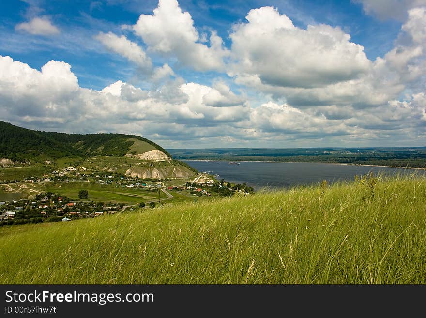 A landskape with a river, hills and clouds. A landskape with a river, hills and clouds