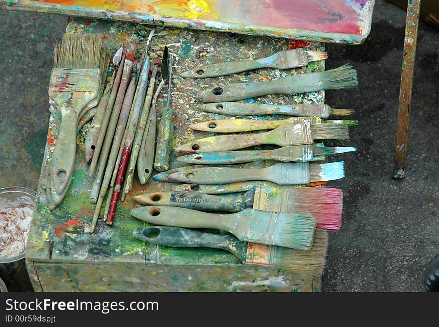 Artist paint palette with paints and brushes