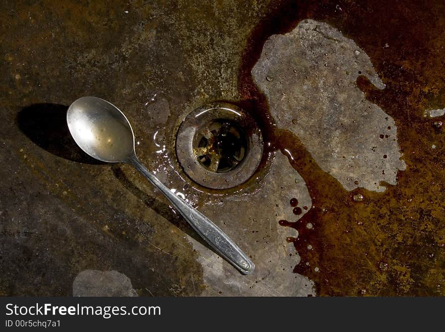 Old rusty bowl, with an aluminium spoon. Old rusty bowl, with an aluminium spoon