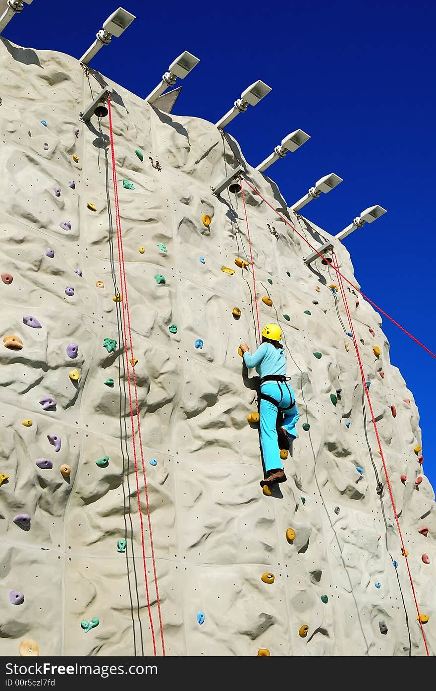 Woman climing a rock wall. Woman climing a rock wall