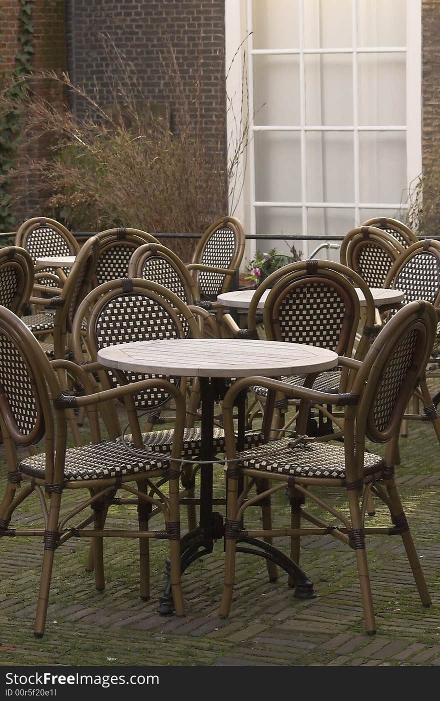 Cafe terrace, a table and a set of rattan chairs, photo taken in Delft, Holland