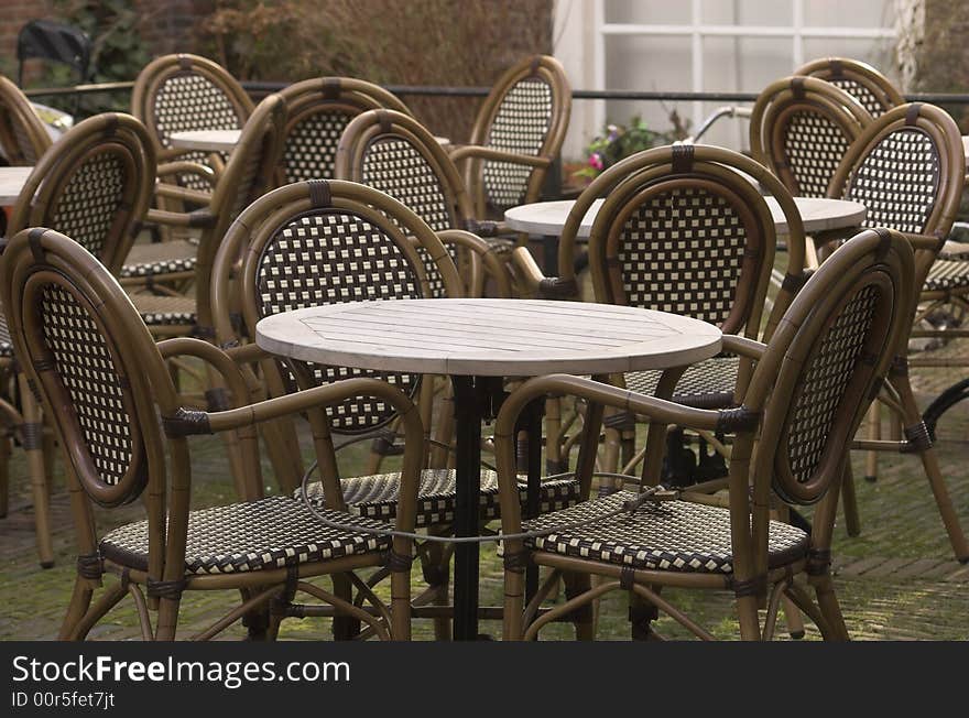 Cafe terrace, a table and a set of rattan chairs, photo taken in Delft, Holland