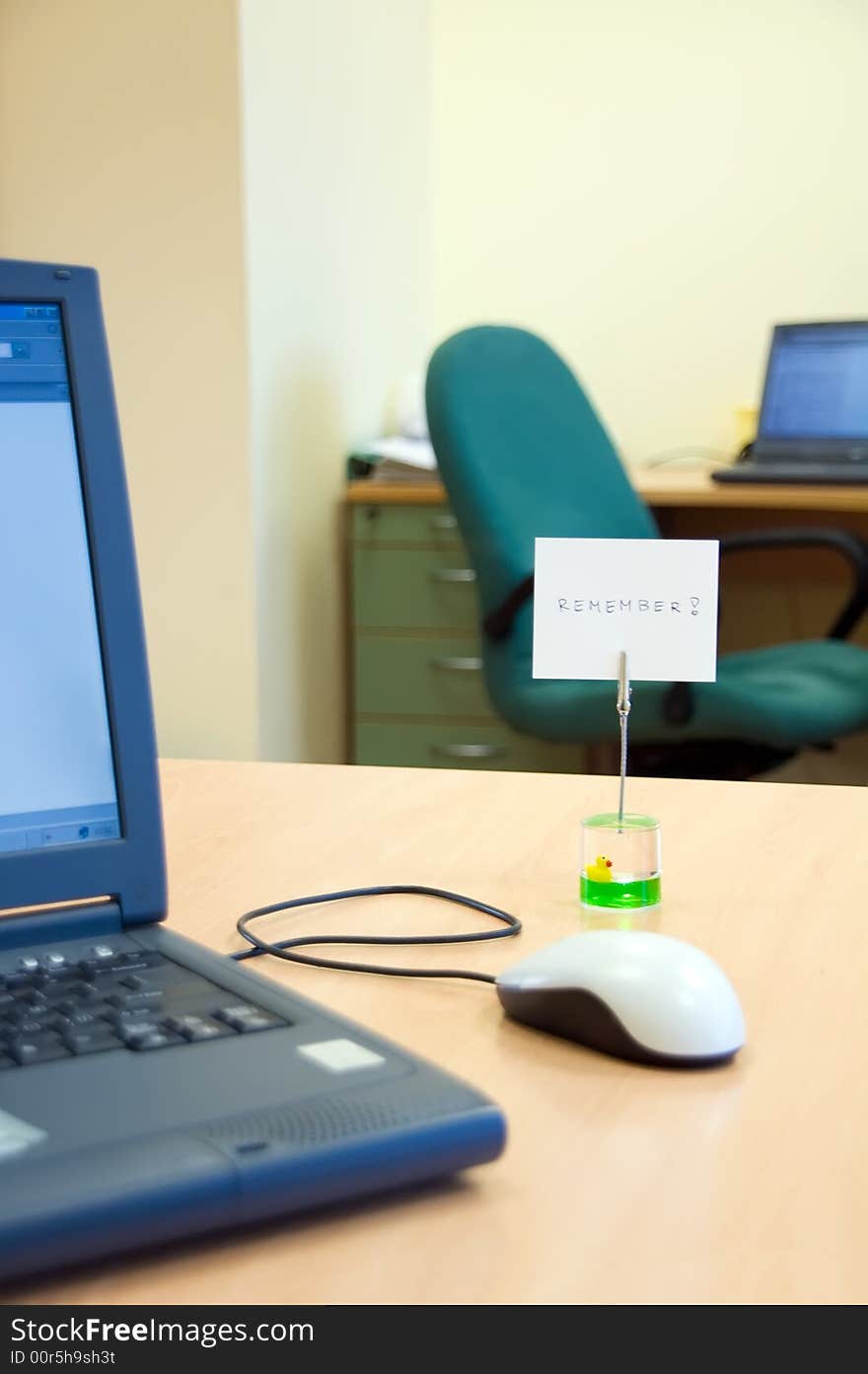 Office desk with laptop computer and reminder note. Office desk with laptop computer and reminder note.