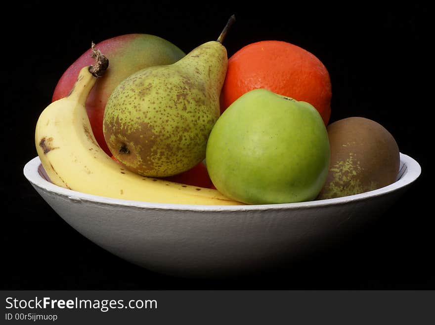 Bowl with fruit isolated on a black background. Bowl with fruit isolated on a black background.