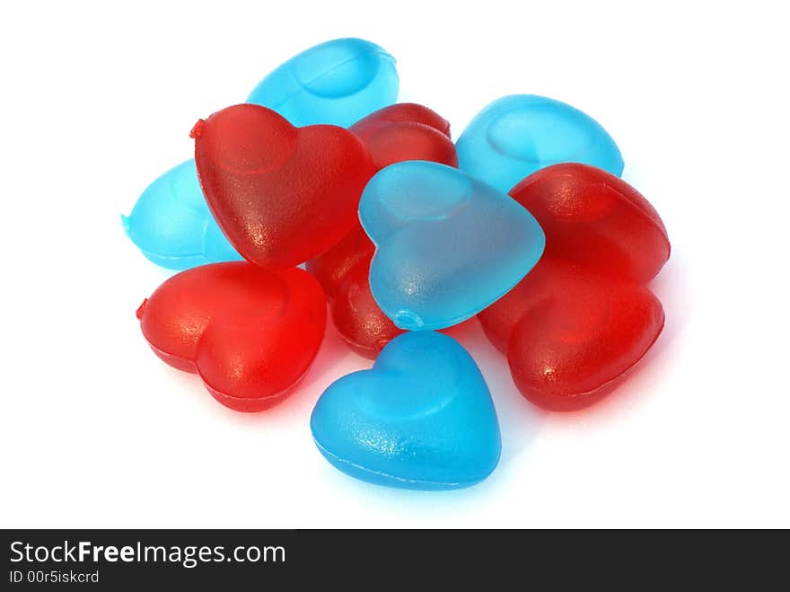 Red and blue heart shaped ice cubes, isolated on a white background. Red and blue heart shaped ice cubes, isolated on a white background.