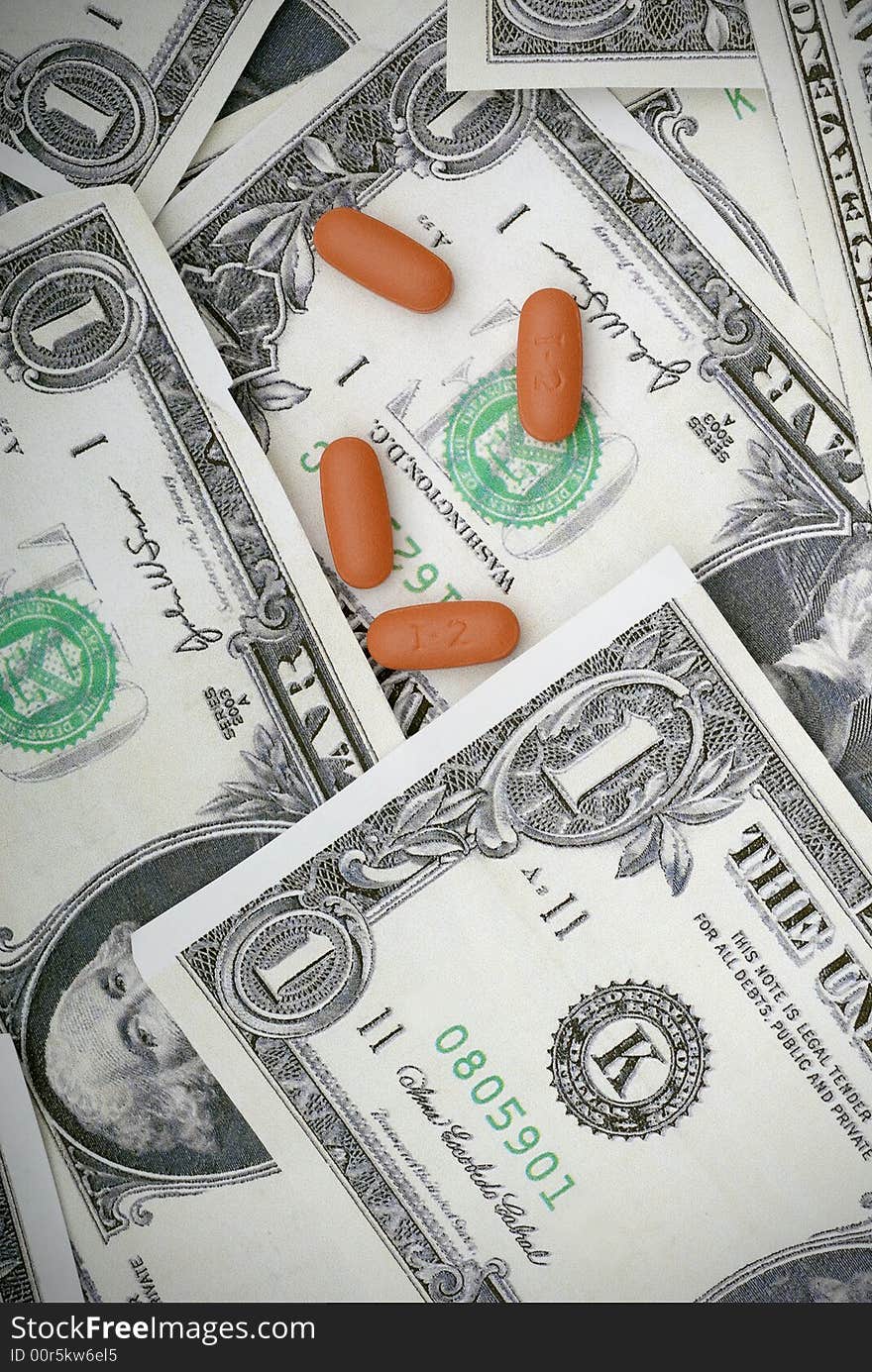 Pills on us currency. Concept of medicating an injured economy, or concept of the cost of medication. Pills on us currency. Concept of medicating an injured economy, or concept of the cost of medication