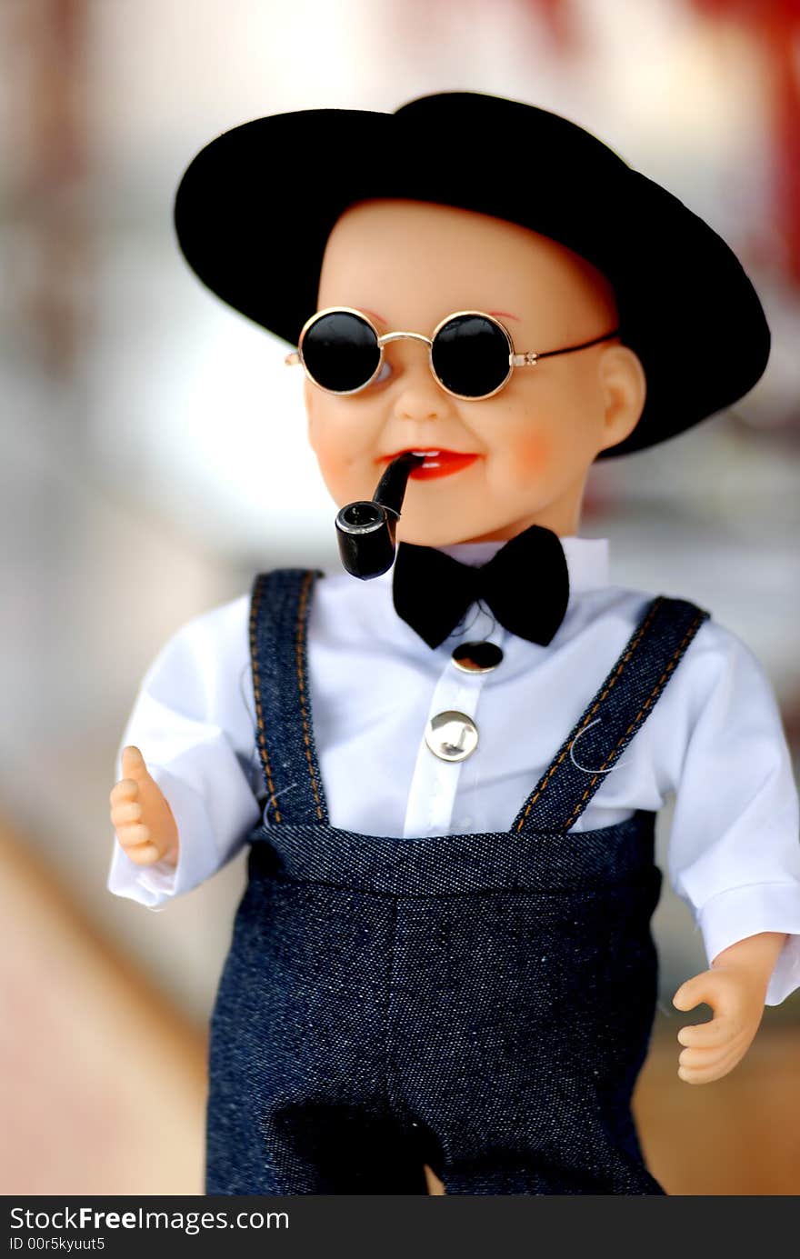 A chinese plastic doll, a boy with shirt, pants,dark sunglasses,cigrette pipe. A chinese plastic doll, a boy with shirt, pants,dark sunglasses,cigrette pipe.