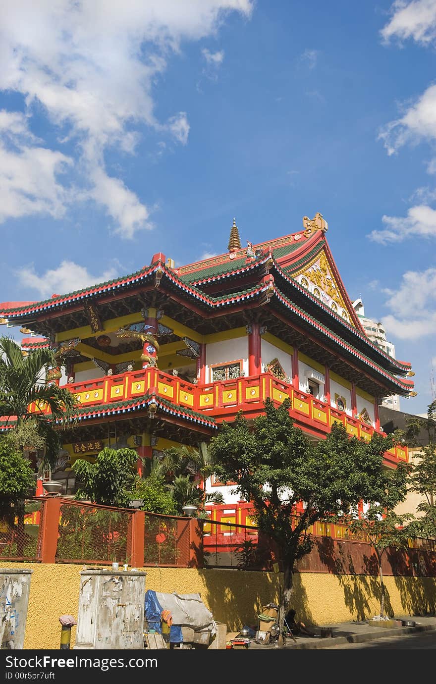 Homeless resting beside the wall of Chinese Temple