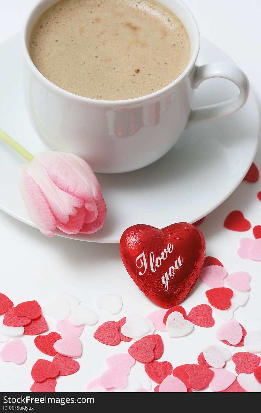 Coffee cup with heart and pink tulip on white background. Coffee cup with heart and pink tulip on white background.