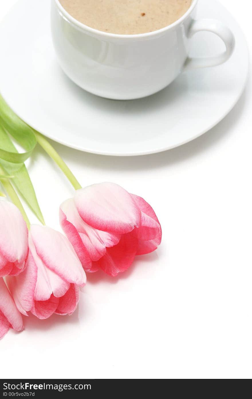 Coffee cup with coffee and pink tulip on white background. Coffee cup with coffee and pink tulip on white background.