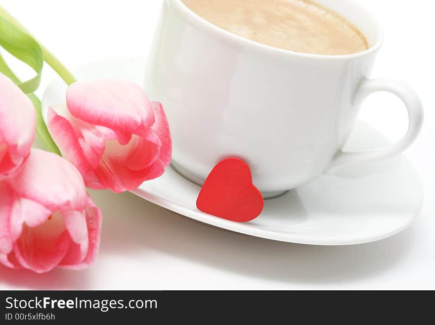 Coffee cupwith coffee,small red heart and pink tulip. Coffee cupwith coffee,small red heart and pink tulip.