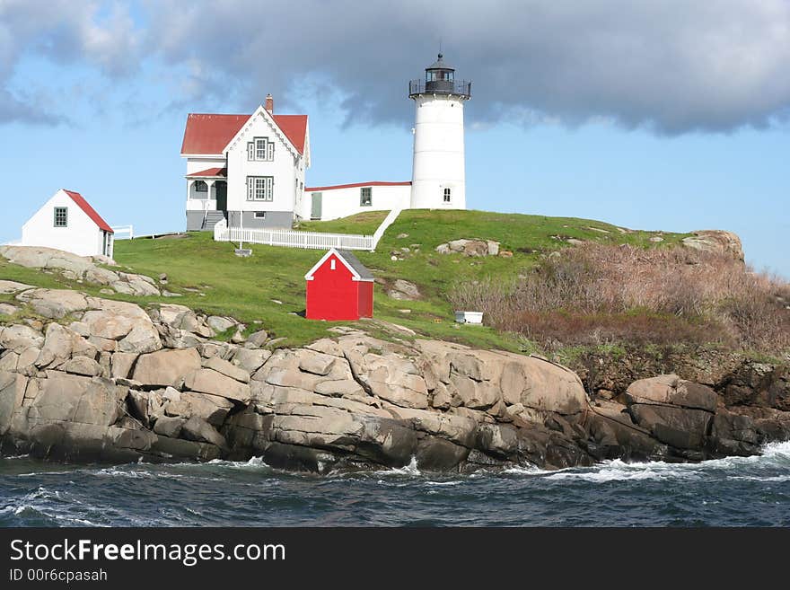 Lighthouse on the coast of Maine,USA.
Showing ocean, rocks,and out-buildings with blue sky & stormy clouds. Lighthouse on the coast of Maine,USA.
Showing ocean, rocks,and out-buildings with blue sky & stormy clouds.