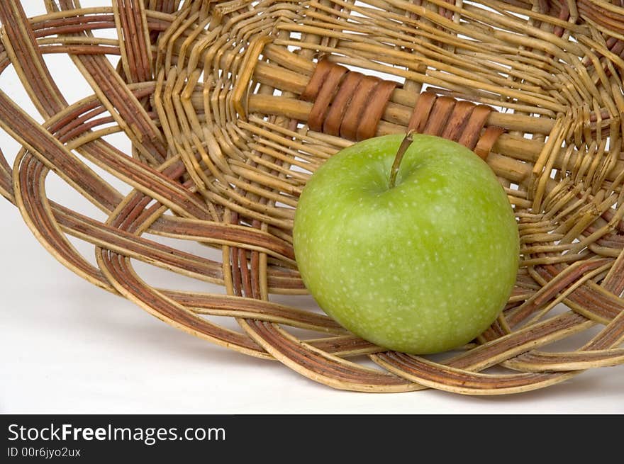 Beautiful green apple on a background of a wum vase. Beautiful green apple on a background of a wum vase.