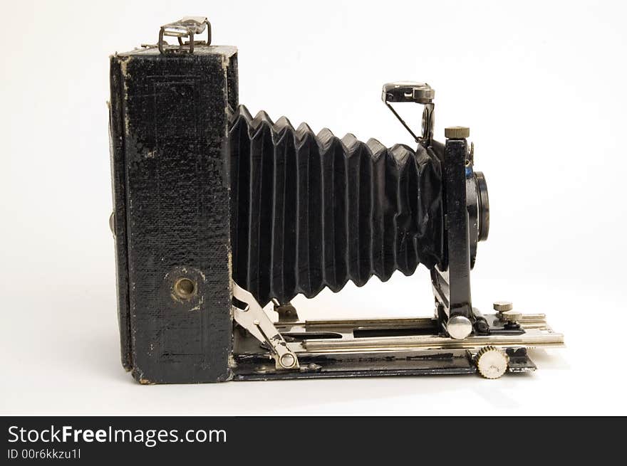 The old photographic chamber with a lens of furs on a white background. The old photographic chamber with a lens of furs on a white background.