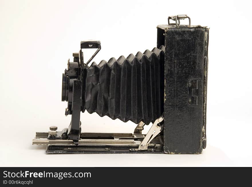 The old photographic chamber with a lens of furs on a white background. The old photographic chamber with a lens of furs on a white background.