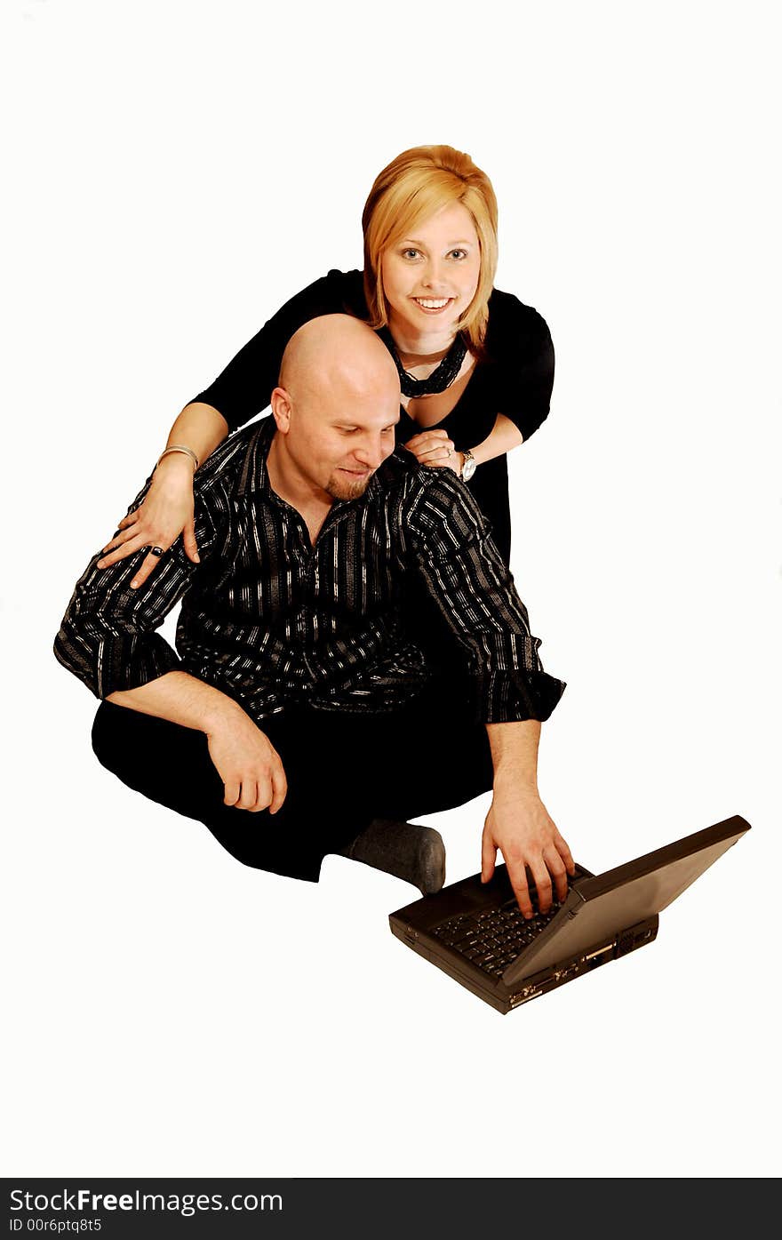 Young lovers sitting on the floor in an studio for white background
and playing on the laptop. Young lovers sitting on the floor in an studio for white background
and playing on the laptop.