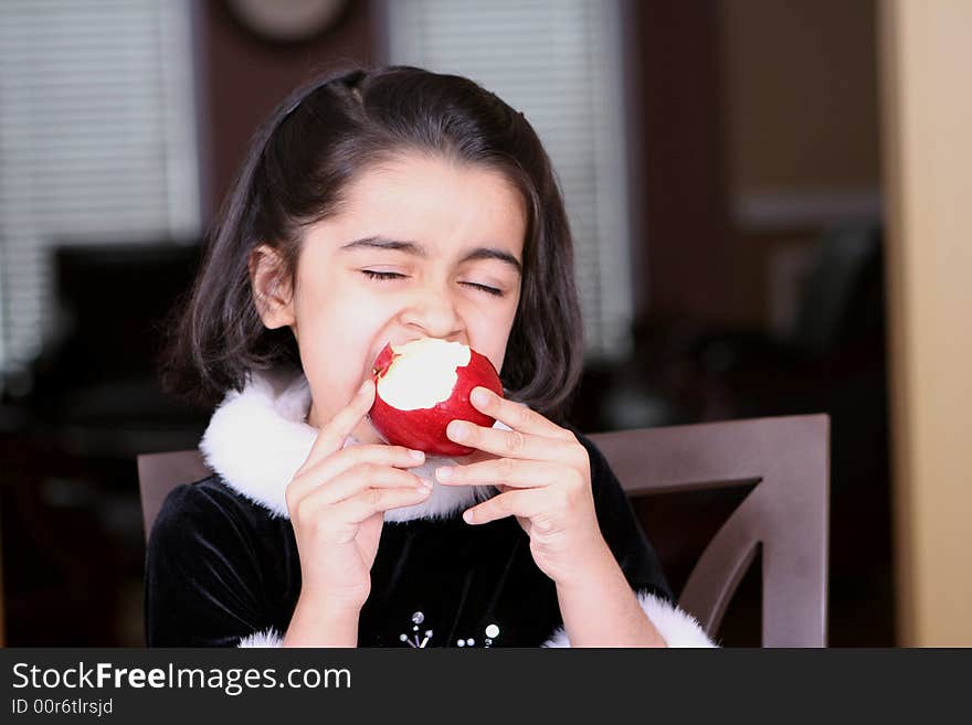 Girl eating apple and enjoying