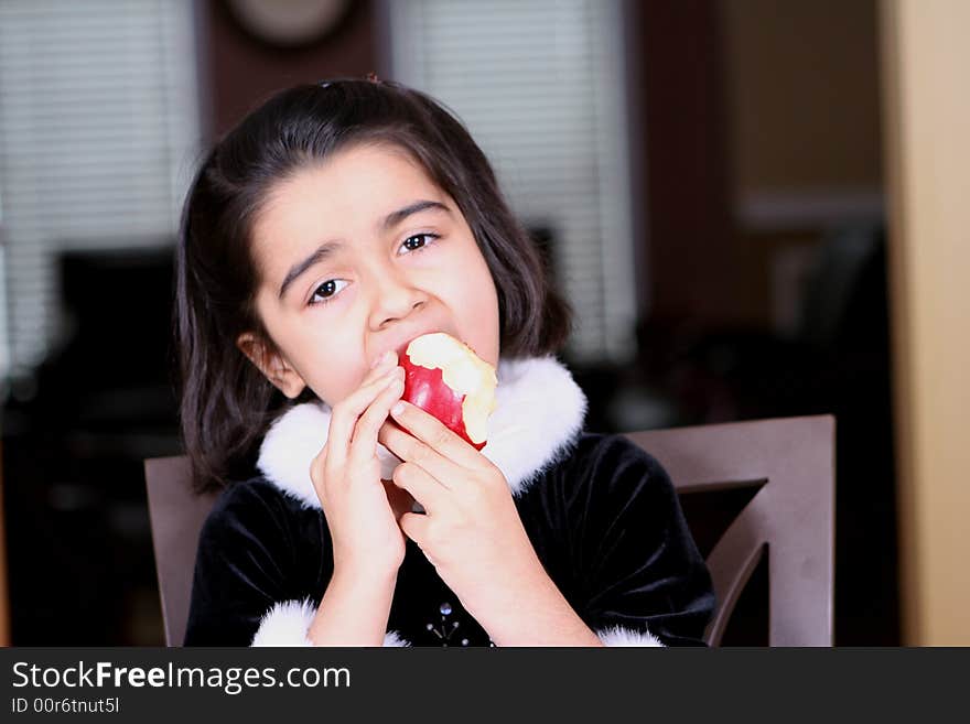 Girl eating apple and enjoying