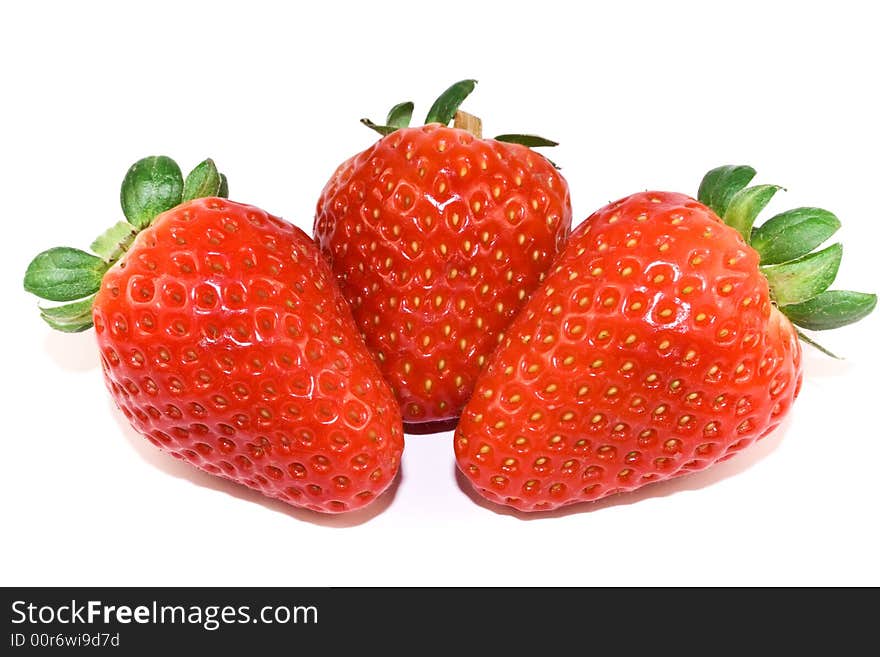 Three strawberries closeup isolated